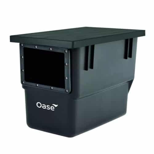 Oase BioSys Skimmer Plus pond edge skimmer with black lid installed beside pond