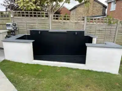 A completed koi pond featuring insulated walls and a seamless fibreglass lining, designed to maintain stable water temperatures and ensure fish health.
