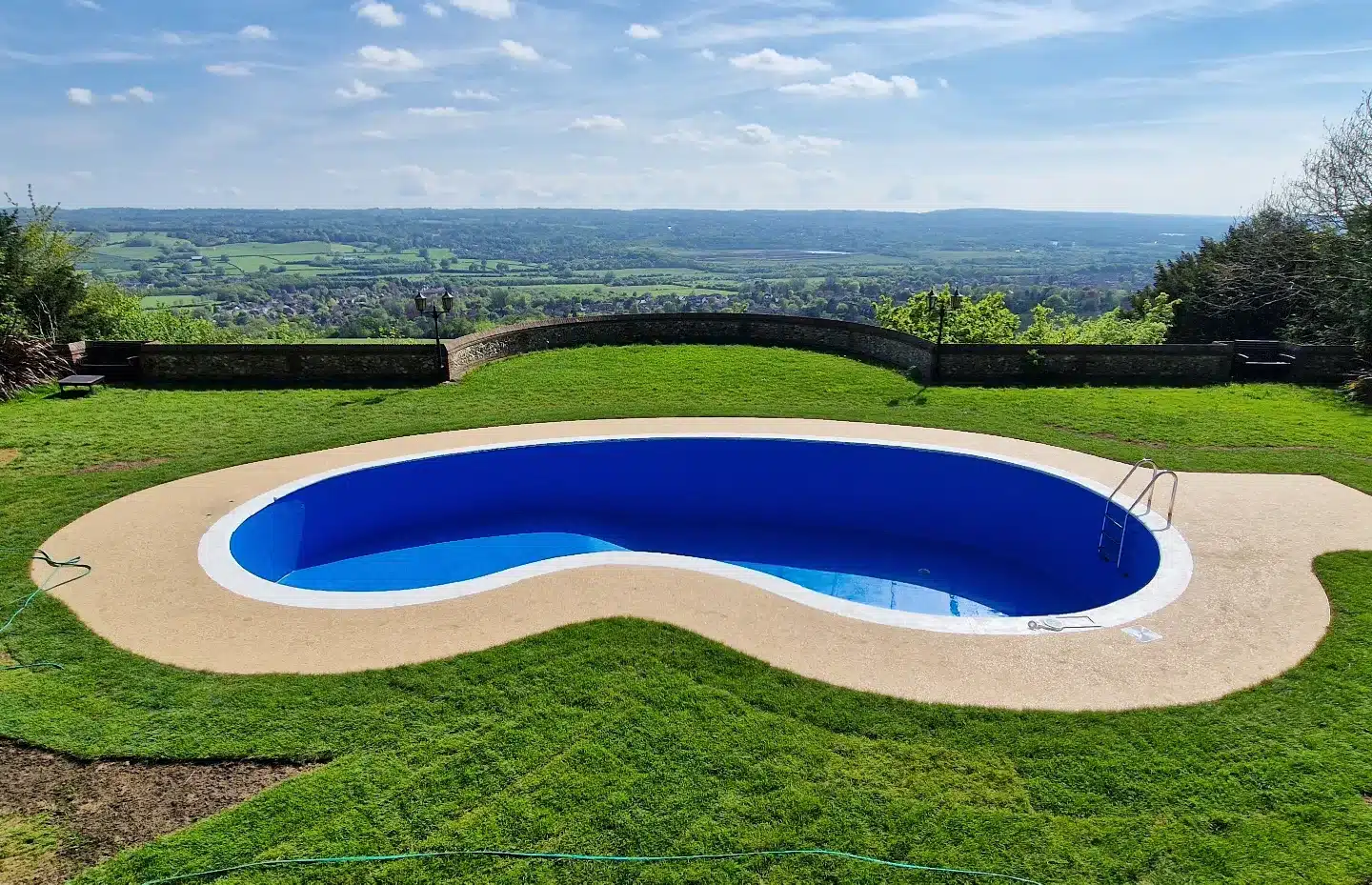 Blue fibreglass swimming pool professionally installed by That Pond Guy in Kent