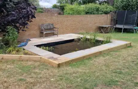 Pond Rebuilt by That Pond Guy in Kent with Paving and Sleepers Around the Edge A beautifully rebuilt pond by That Pond Guy in Kent, featuring elegant paving and wooden sleepers around the edge for a natural and stylish finish.