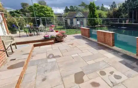 Large Patio Area Paved by That Pond Guy in Front of a Huge Koi Pond They Built A spacious patio area beautifully paved by That Pond Guy, complementing the huge koi pond they built, creating a perfect outdoor retreat.