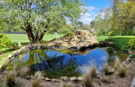 Large Koi Pond with Big Waterfall Built by That Pond Guy in Kent A beautifully designed large koi pond with a powerful, cascading waterfall, expertly built by That Pond Guy in Kent for a dramatic and natural look.