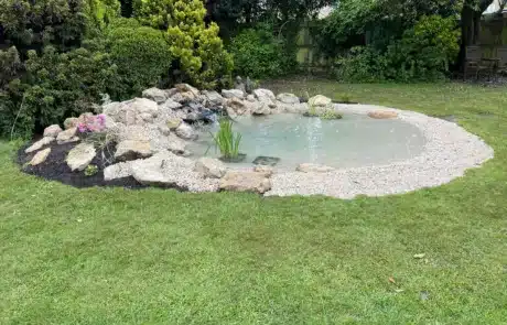 Natural-Looking Wildlife Pond Built by That Pond Guy in Kent Using Cotswold Stones A beautifully crafted natural-looking wildlife pond built by That Pond Guy in Kent, designed with Cotswold stones for an authentic and picturesque finish.