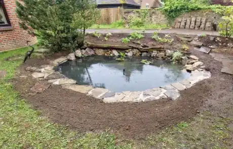 Natural-Looking Pond Relined and Rebuilt by That Pond Guy in Sevenoaks A beautifully relined and rebuilt natural-looking pond by That Pond Guy in Sevenoaks, seamlessly blending into the surrounding landscape.