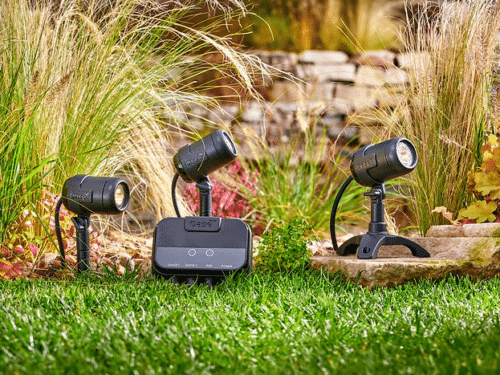LunAqua Connect LED spotlights illuminating a garden landscape, showcasing smart-controlled outdoor lighting.