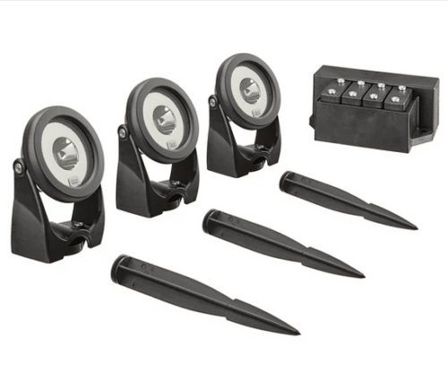 A complete set of OASE LunAqua Power LED Set 3 with three LED spotlights, support brackets, ground pegs, and a waterproof driver for pond and garden lighting.