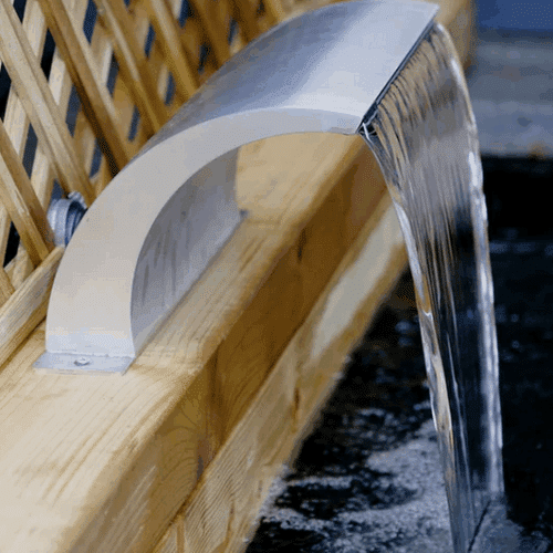 Arc Waterfall in polished stainless steel with curved spout and flexible back or bottom inlet options for ponds, pools, and garden landscapes. Water flowing