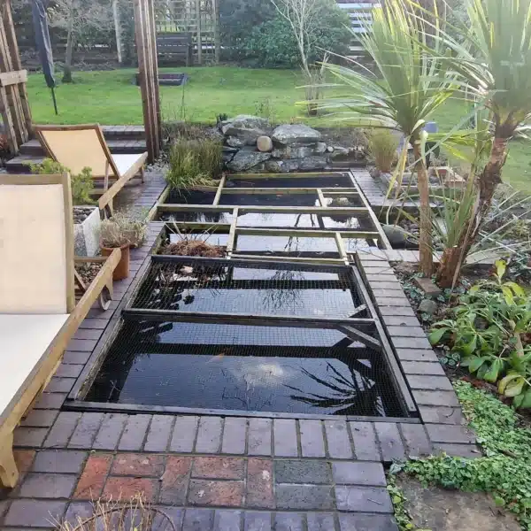 Overgrown pond before cleaning with heavy debris and algae in Sevenoaks, Kent