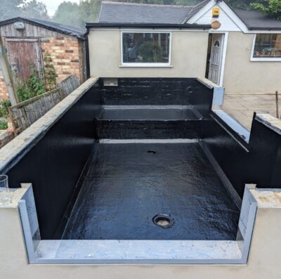Completed fibreglass pond lining in London with smooth blue GRP finish