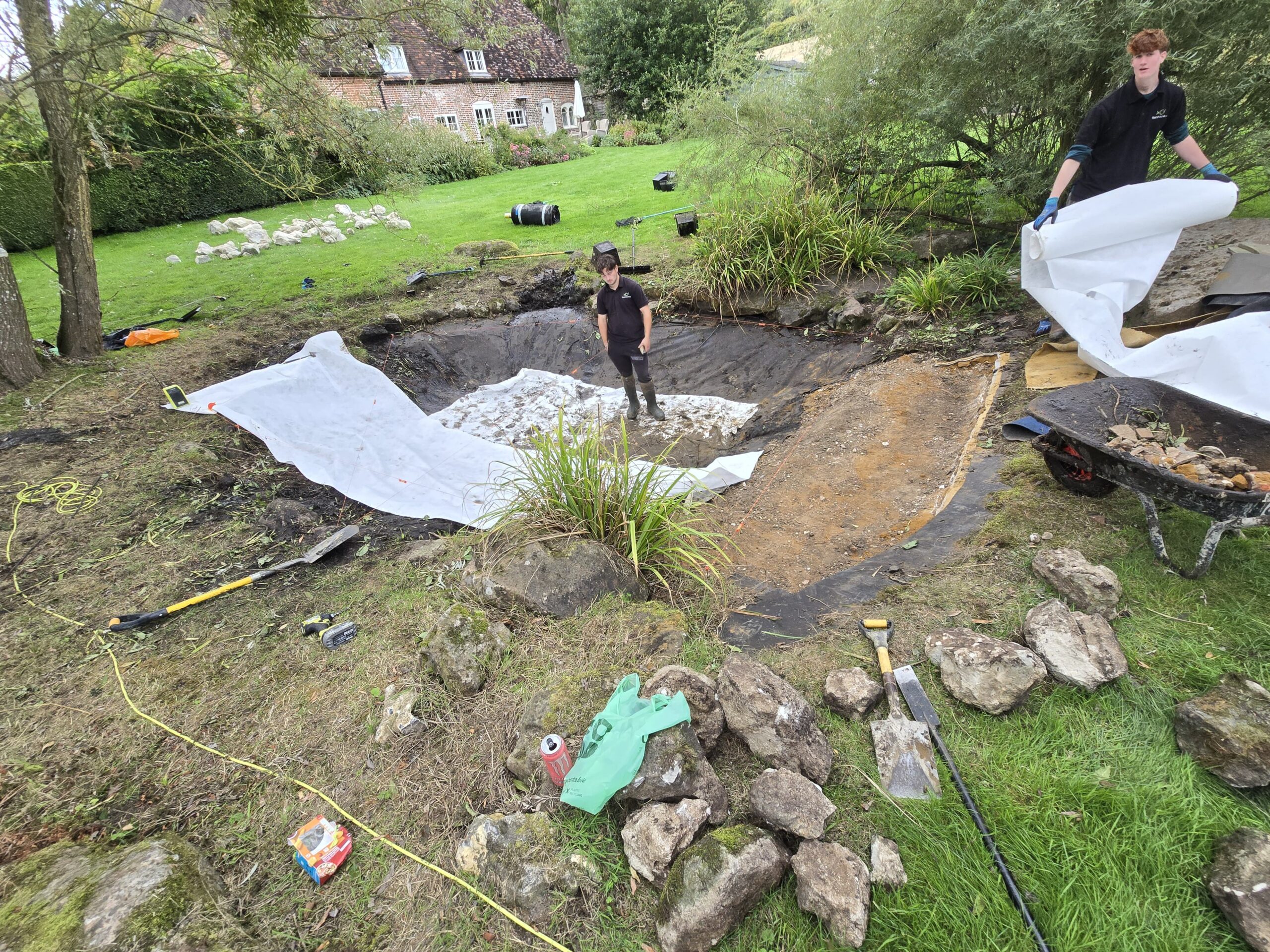 Pond drained and cleaned during pond relining to locate the cause of the leak