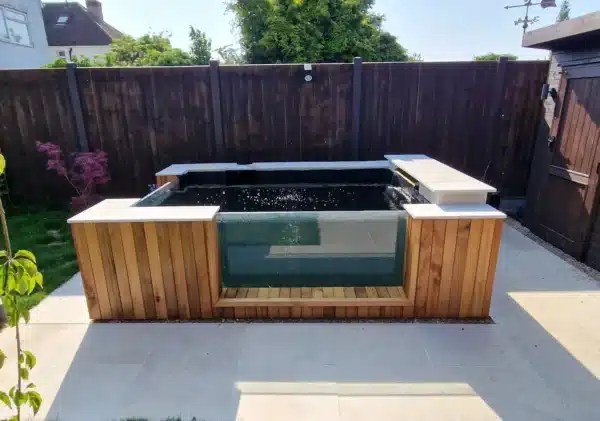 Completed fibreglass pond lining in Essex with smooth blue GRP finish