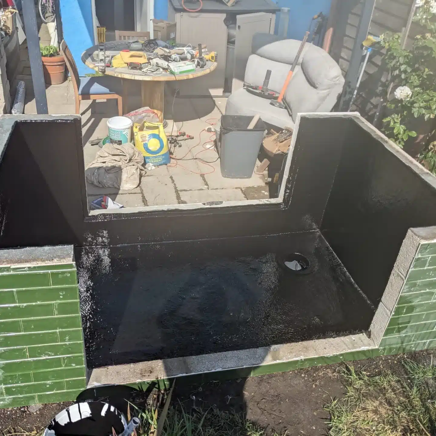 Completed fibreglass pond lining in Surrey with smooth blue GRP finish